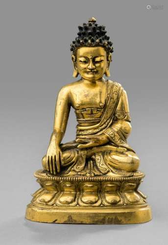 A GILT-BRONZE FIGURE OF BUDDHA SHAKYAMUNI, China, 16th/17th ct., seated in vajrasana on a lotus base with his right hand in bhumisparshamudra while the left is resting on his lap, wearing monastic robe, his face displaying a serene expression with downcast eyes and curled hair-dress and ushnisha, unsealed - Provenance: Property from a German private collection, acquired at Sotheby's Paris, 11 Dec 2014, Lot 190 - Minor wear