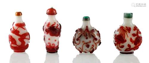 A GROUP OF FOUR PEKING GLASS SNUFF BOTTLES, China, 2nd half of the 19th ct. - Opaque white glass with red overlay, most likely flashed glass, some traces of glass wire application, the cutting technique and designs typical of the 19th ct. flower patterns - From the collection of a member of the Family Baron von Goldschmidt-Rothschild, formerly Palais Grüneburg, Frankfurt on the Main - Good condition