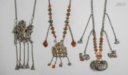 A GROUP OF THREE SILVER NECKLACES WITH FIGURAL AND ZOOMORPHIC PENDANTS, China, late Qing/early Republic period - Decorated with auspicious symbols and enblematic figures riding the Qilin, two necklaces with gemstone beads - Property from an Austrian private collection, acquired between 1983 and 1991 - Traces of previous embellishment, good condition