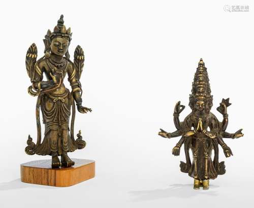 TWO BRONZES DEPICTING A BODHISATTVA AND EKADASHALOKESHVARA, Tibeto-Chinese, 18th and 19th ct., one on base. The first standing in samabhanga with both hands showing the vitarkamudra and holding stems of lotuses flowering along the upper arms, wearing dhoti, scarf and bejewelled and his face displaying a serene expression; and Ekadashalokeshvara standing in samabhanga with his principle hands in anjalimudra and showing eleven heads - Property from a German private collection, assembled in the 1970s and 80s - Wear, one bronze with lost feet