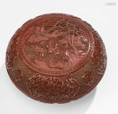 A 'SCHOLARS AND PUPILS' CINNABAR LACQUER BOX, China, 18th/19th ct., Carved in deep relief to depiect two scholars with their two pupils under a large pine tree in a rocky mountainous landscape, with some foggy clouds in the distance, in a centered medallion on the domed cover, which is surrounded by a meandering border. The sides show one border on the cover and the base, each with four rectangular resvers bearing a Chrysanthemum flower surrounded by leaves and tendrils. A second meandering border is set around the raised footrim. - Former property from an Austrian private collection - Few age cracks, small chips as well as one major chip to the lower rim