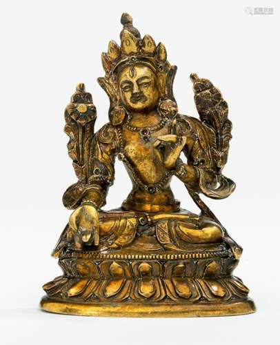 A BRONZE FIGURINE OF SITATARA, Tibeteo-Chinese, late 18th ct., seated in vajrasana on a lotus base with her hands in varada and vitarkamudra, wearing sari, scarf and bejewelled, her face is displaying a serene expression and her chignon secured with a tiara, unsealed - Property from an old European private collection, assembled prior 1990 - Very minor wear, very slightly chipped, one finger replaced