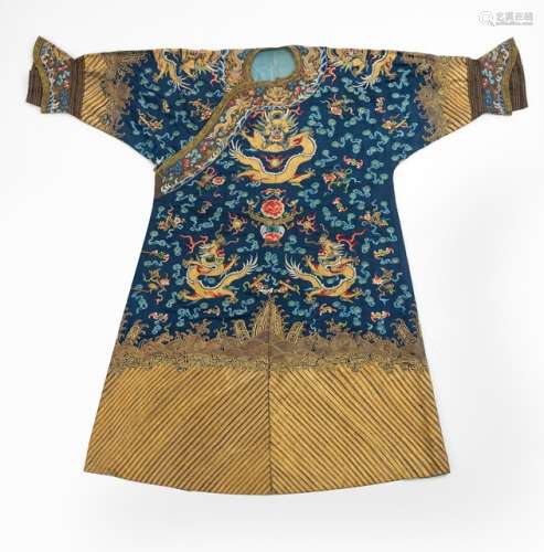 A SEMI-OFFICIAL NINE DRAGON ROBE WITH GOLD AND FLOSS SILK EMBROIDERY ON BLUE SATIN GROUND, China, 19th ct. - Property from a German private collection, gifted 2007 to the present owner - Arms modified