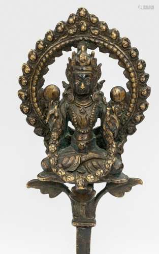 A BRONZE FIGURE OF AN OFFERING DEITY, Nepal, 18th/19th ct., on base. Seated in vajrasana on a lotus pericarp with both hands extending a garland, wearing a dhoti, bejewelled, his face displaying a serene expression with downcast silver inlaid eyes and a flaming halo behind - Property from a German private collection, assembled in the 1970s and 80s - Very slightly chipped, minor wear