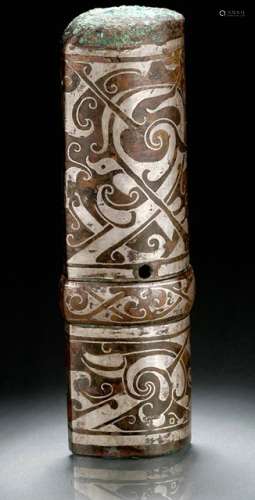 A SILVER INLAID BRONZE SPEAR-HAFT CAP, China, probably Han dynasty, 3rd/ 2nd. ct. BC. The tubular sheath of almond-shaped section, with a raised band and a hole for attachment. Inlaid with formal scrolling motifs and diagonal lines. - Provenance: Bought in 1998 from L.H.W. Investment & Trading Limited, Hong Kong. - Described and illustrated in: Regina Krahl: Collection Julius Eberhardt. Early Chinese Art, vol. 1, Hong Kong 1999, p. 122f.