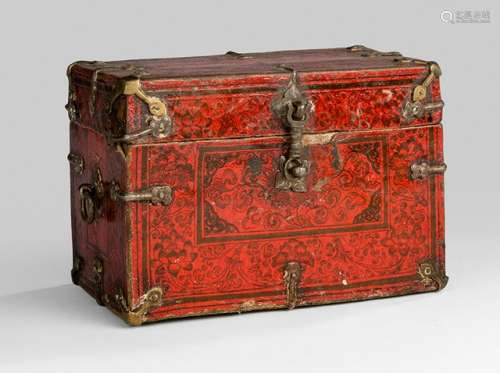 A METAL MOUNTED WOOD CASKET, TIBET, ca.16th/17th ct., the wood casket covered with red lacquered cotton painted with a design of scrolling tendrils and geometric motifs, a looped ring to each side and a lock to the front - Property from an European private collection, assembled in London in the 1970s and 80s - Very minor damages due to age