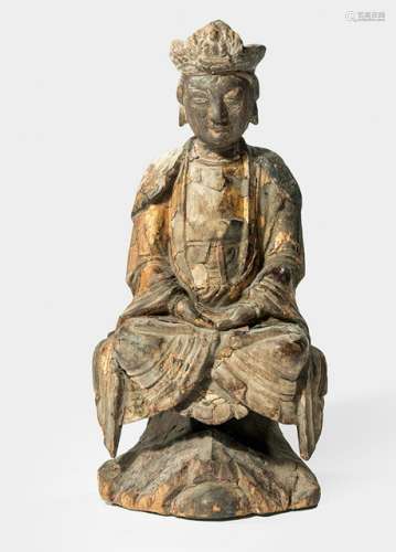 A  WOOD FIGURE OF GUANYIN, CHINA, 17th/18th ct., seated in vajrasana on a rock formation with both hands resting in dhyanamudra on her lap, wearing various garments including a wide-sleeved mantle and her face is displaying a serene expression, traces of gilt-lacquer - Property from a German private collection, assembled in the 1970s and 80s - Minor damage due to age