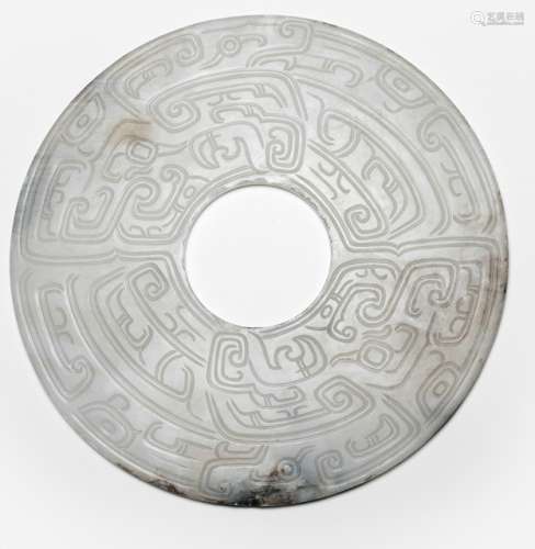 A WHITE JADE 'BI' DISC WITH ABSTRACT 'TAOTIE' DECOR, China, Ming dynasty. Carved on both sides with few grey-brown inclusions. - Property from an important German private collection, acquired at Blue Elephant, Maastricht, 1999 - Very minor chips to the outer and inner rim