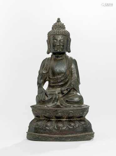 A BRONZE FIGURE OF BUDDHA SHAKYAMUNI, CHINA, 16th ct., seated in vajrasana on a lotus base with his right hand in bhumisparshamudra and the left resting on his lap, wearing a monastic garment, his face displaying a serene expression with downcast eyes, the curled hair and ushnisha topped with a lotus-bud - Property from an old Bavarian private collection, assembled by the father of the present owner till the 1980'ies - Base with very small losses and few dents