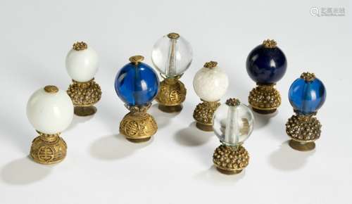 A GROUP OF EIGHT GILT-BRONZE MOUNTED MANDARIN HAT FINIALS, one made of crystal, seven made of glass, China, late Qing dynasty - Property from an old German family collection, assembled in China around 1912 - Minor traces of age