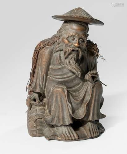 A CARVED BAMBOO FIGURE OF A SEATED FISHER MAN WITH BASKET AND HEAD, China, Qing dynasty - Property from an old German industrialist collection, assembled between 1950 and 1990 - Very minor damage due to age