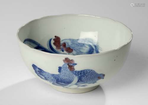 A PORCELAIN BOWL WITH UNDER GLAZE BLUE DECORATION OF A ROOSTER AND HENS