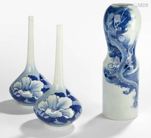 A PAIR OF PORCELAIN VASES DECORATED WITH HIBISCUS IN UNDERGLAZE BLUE AND ONE PORCELAIN VASE WITH A DRAGON AMONG CLOUDS