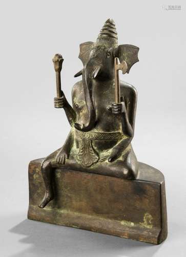 A BRONZE FIGURE OF THE FOUR-ARMED GANESHA SEATED ON A PEDESTAL