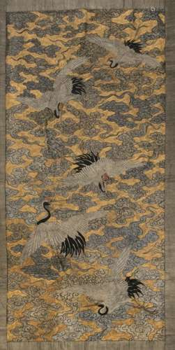 A FINE EMBROIDERY HANGING DEPICTING FIVE MANCHURIAN CRANES AMIDST GOLDEN AND SILVER CLOUDS