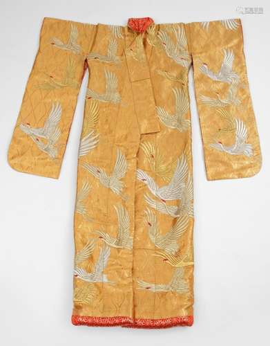 AN ORNATE BROCADE KIMONO WITH DENSE GOLD AND SILVER PATTERN OF WAVES