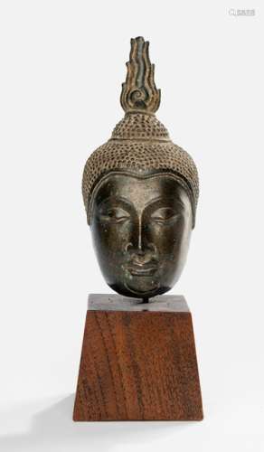 A BRONZE FRAGMENT OF A BUDDHA HEAD