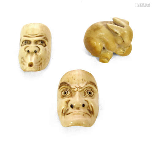TWO CARVED IVORY MASKS AND A RABBIT NETSUKE
