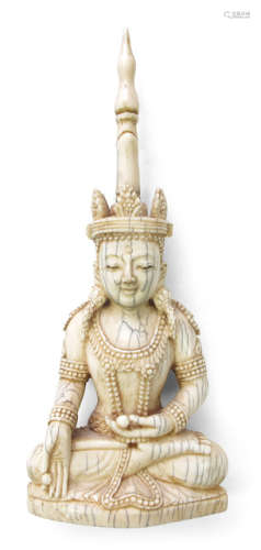 AN IVORY FIGURE OF THE SEATED BUDDHA HOLDING TWO SPHERES
