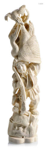 AN IVORY OKIMONO OF A RIFLEMAN WITH A CRANE AND AN EAGLE SEATED ATOP HIS HEAD