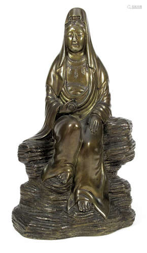 A BRONZE FIGURE OF MONJU BOSATSU SEATED ON A ROCK