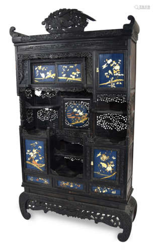 A WOOD CABINET WITH CARVED AND PIERCED DECORATIONS AND LACQUER PANELS INLAID WITH BONE
