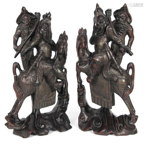 A PAIR OF HARDWOOD FIGURES WITH BRASS INLAYS DEPICTING TWO WARRIORS ON HORSEBACK