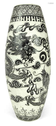 A WHITE AND BLACK PORCELAIN VASE DEPICTING TWO FIVE-CLAWED DRAGONS AMONG CLOUDS