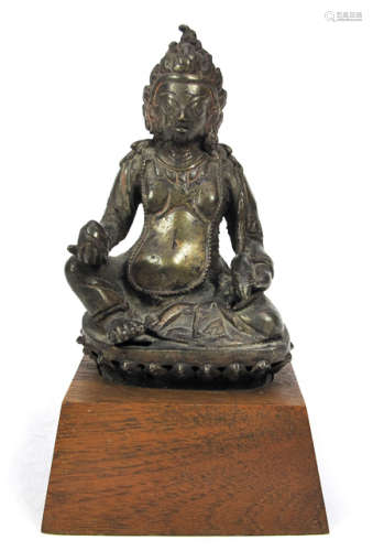 A BRONZE FIGURE OF VAJRAVANA SEATED ON A LOTUS THRONE