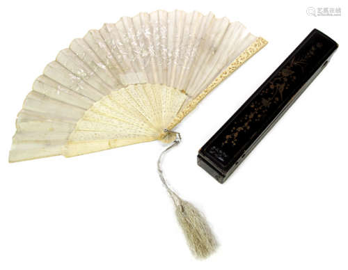 A FINE CARVED IVORY AND TEXTILE FAN