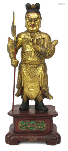 A RED AND GOLD PAINTED WOOD FIGURE OF A GUARDIAN