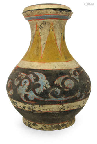 A PAINTED CLAY URN AND COVER