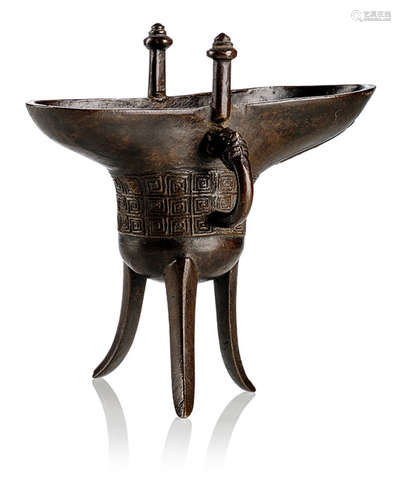 A BRONZE JUE IN ARCHAIC STYLE