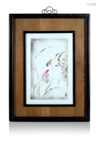 A PAINTED BIRD AND LOTUS PORCELAIN PANEL MOUNTED IN A WOODEN FRAME