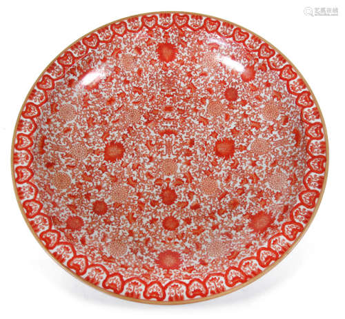 A LARGE IRON RED GLAZED PLATE DEPICTING FLOWERS