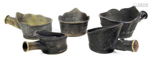 FIVE BRONZE IRONS WITH ENGRAVED PATTERN