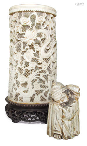 AN IVORY DRAGON BRUSH HOLDER AND A MAMMOTH FIGURE OF A SLEEPING MONK