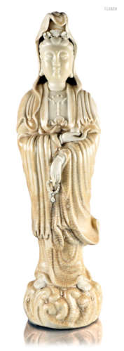 A PORCELAIN FIGURE OF STANDING GUANYIN WITH PARTLY CREME COLOURED AND CRACKELED GLAZE