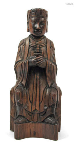 A WOODEN FIGURE OF A SEATED OFFICIAL