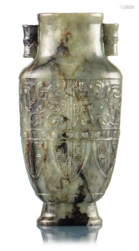 A GREEN AND BLACK JADE VASE IN ARCHAIC STYLE DEPICTING TAOTIE MASKS