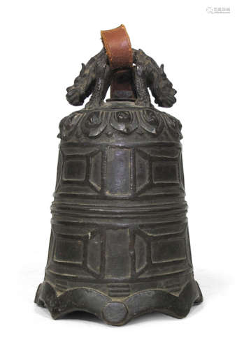 AN IRON BELL WITH GEOMETRIC PATTERN IN RELIEF