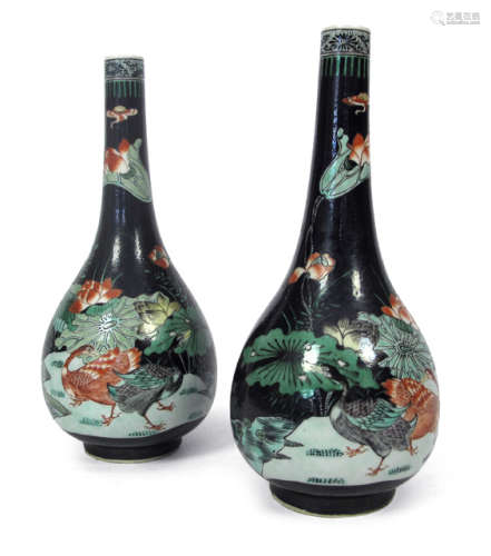 A PAIR OF RED AND GREEN DECORATED PORCELAIN VASES DEPICTING LOTUS AND DUCKS ON BLACK GROUND