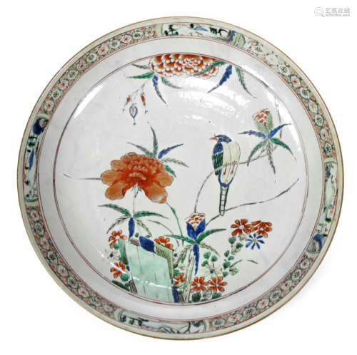 A POLYCHROME DECORATED PORCELAIN PLATE DEPICTING A BIRD AND FLOWERS