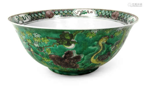 A PORCELAIN BOWL RICHLY DECORATED WITH BIRDS AND PLANTS ON GREEN GROUND