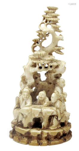 A CARVED IVORY GROUP OF SCHOLARS PLAYING A BOARD GAME