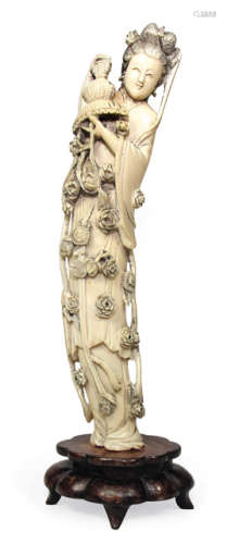 AN IVORY CARVING OF A STANDING LADY WITH NUMEROUS BLOSSOMS