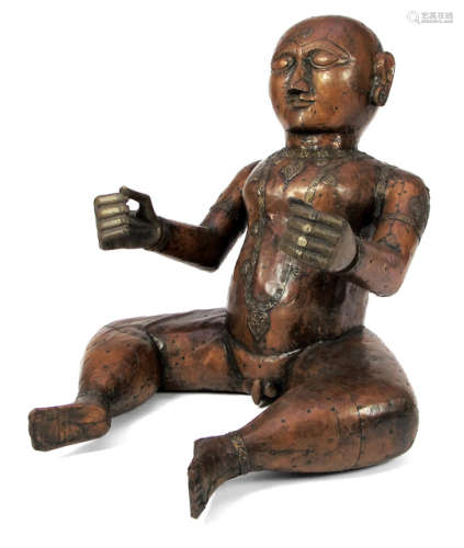 A COPPER SHEATH COVERED WOOD ACUPUNCTURE MODEL OF A YOUNG BOY