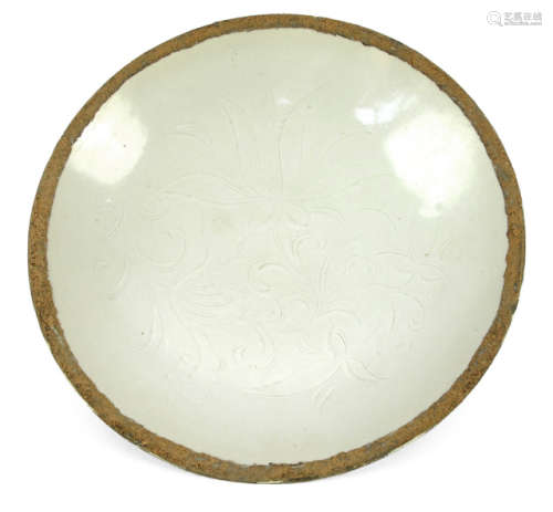 A LOW MOULDED DING WARE PLATE WITH ENGRAVED FLORAL PATTERN