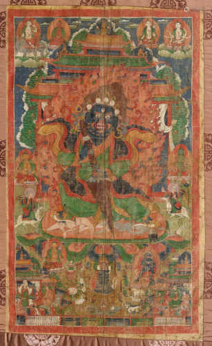 A THANGKA OF A PROTECTIVE DEITY WITH A KILA. Tibet, 18th/19th c. 82x51 cm. Framed under glass. Somewhat damaged.