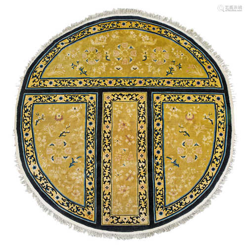 A RARE YELLOW-GROUND CIRCULAR WOOL CARPET WITH FLORAL DESIGNS. China, Republican Period, D 214 cm.